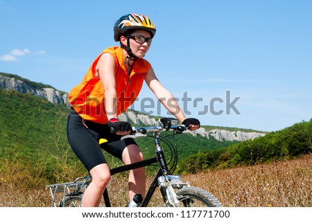 A young female riding a mountain bike outdoor