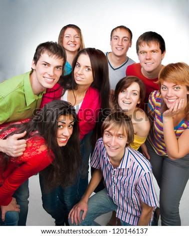 group of casual happy people smiling and standing over a light background