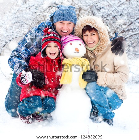 Happy Smiling Family With Snowman Winter Portrait