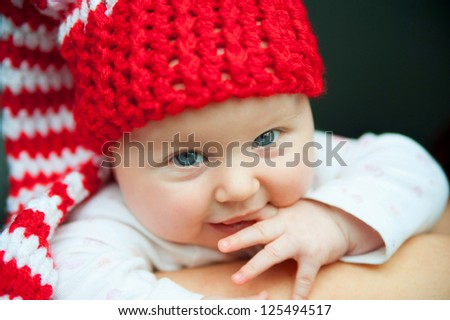 child of tender years in red hat