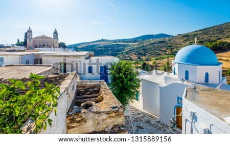 Typical whitewashed church with blue dome on the corner of the street, Lefkes, Paros island, Greece