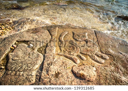 CRIMEA - MAY 06: New tourist attraction - Rock carvings on the seashore (cat and head) created by an unknown contemporary author near Sevastopol (Crimea), Ukraine, May 6, 2013.