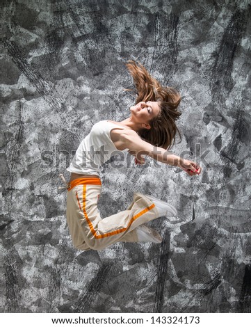 jumping girl on a gray grunge background