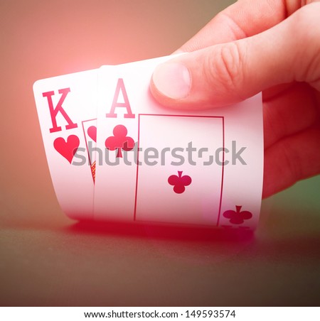 playing cards in hand on a green table casino
