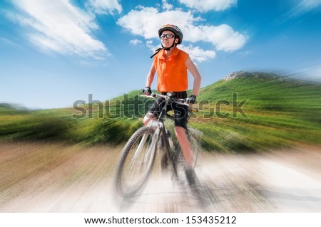 Person riding a mountiain bike on a slope with blur background
