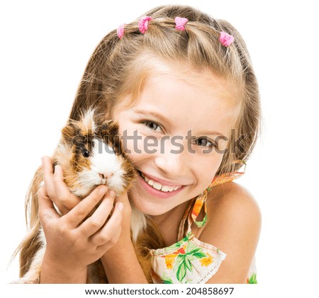 Cute little girl holding a guinea pig Isolated on white background Cute little girl holding a guinea pig Isolated on white background
