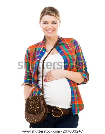 Beautiful pregnant white woman wearing shirt with hands on belly isolated
