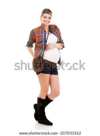 Beautiful pregnant white woman wearing shirt with hands on belly