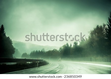 winding mountain road in the fog
