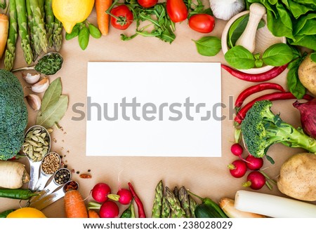 Fresh vegetables on a brown background with white paper, frame