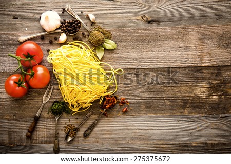 raw Italian paste with tomatoes and spices on a wooden cook-table
