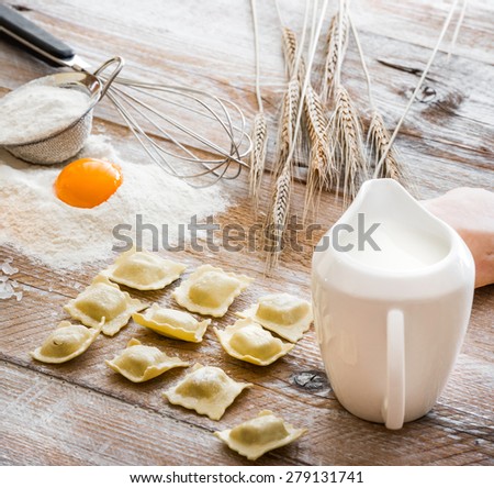 Ravioli on a wooden flour board