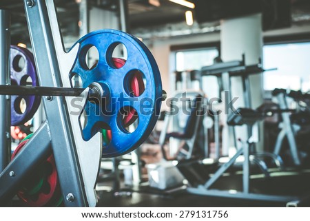Rod with weights in the gym