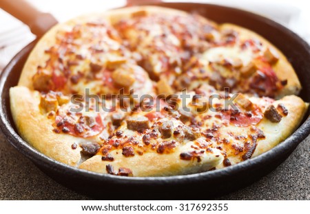 cut delicious pizza in a pan