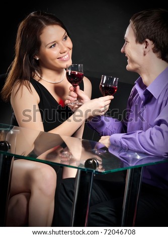 beautiful young couple drinking wine