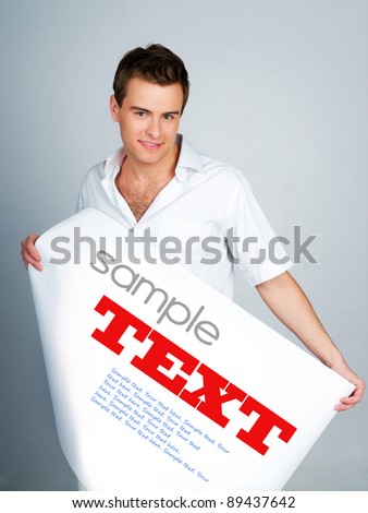 young man holding a paper with sample text