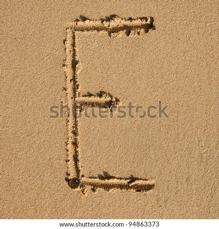 English alphabet in the sand