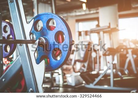 Rod with weights in the gym