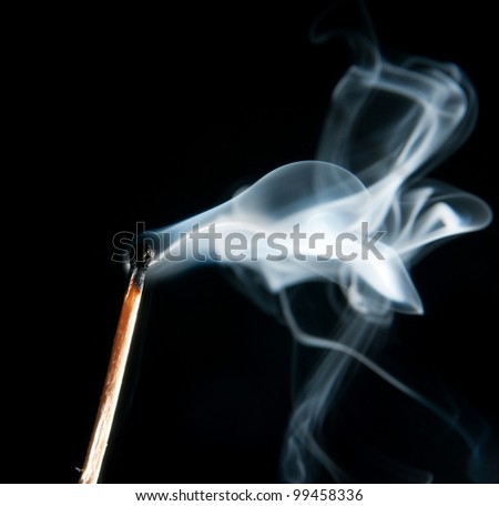 extinguished the match with smoke on black background