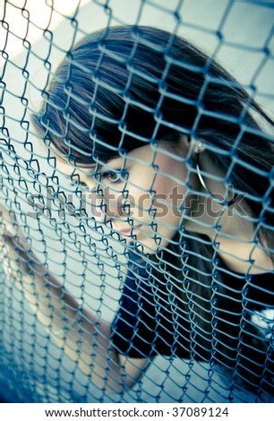 portrait of beautiful woman behind bars