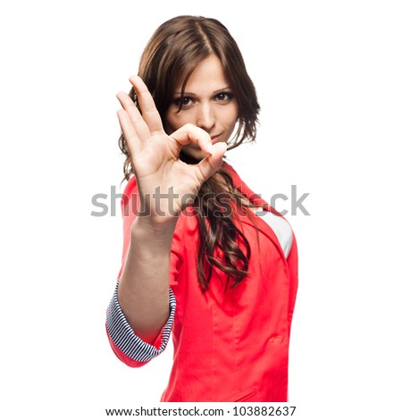 Young business woman doing Ok gesture. Focus on hand