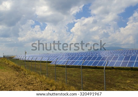 Lots of solar panels behind rusty barbed wire in the field near Sofia