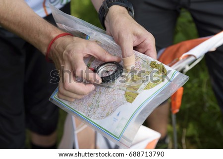 Compass and map for orienteering. Selective focus