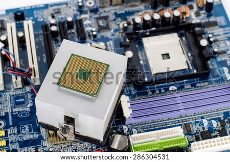 CPU laying on the radiator with motherboard on background