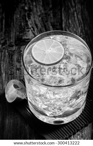 Classic margarita cocktail on wooden table with limes,Black and White