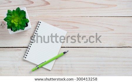 Office desk table with note paper and flower. Top view with copy space