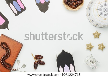 Table top view aerial image of decoration Ramadan Kareem holiday background.Flat lay date in wood basket with white rosary & green tea.Halal meal set for fasting is obligatory for Muslim on wooden.