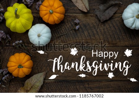 Table top view aerial image of decoration Happy Halloween or Thanksgiving day background concept.Flat lay accessory object to party the pumpkin & dry flower on brown wooden.Text for season design.