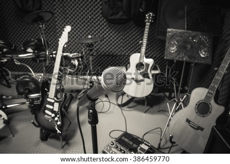 selective focus microphone and blur musical equipment guitar ,lyric, drum piano background.