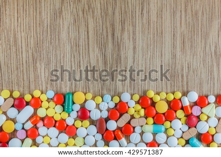 Top view medicine background concept  the many medicine pills,capsules,drugs,tablets on wood table texture background.