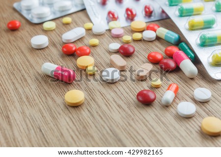 medicine background concept the medicine drugs, pills, capsule, tablets,drugs packaging on wood table  texture background.