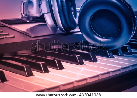 headphones on electric piano background by the  music background or music instruments background.