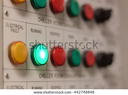 Soft focus industrial background the electrical running engine lighting on control panel board at electrical safety room .