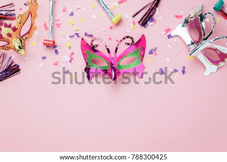 Table top view aerial image of beautiful colorful carnival mask or photo booth prop background.Flat lay object on modern rustic pink wallpaper at  office desk studio.space for creative design mock up.