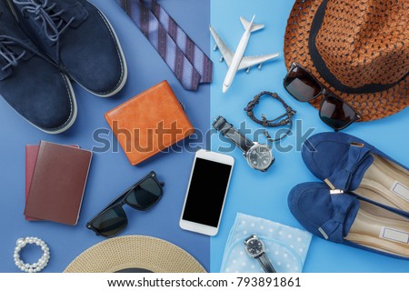 Flat lay image of accessory clothing man or women to plan travel in holiday background concept.Mobile phone & passport with items in vacation season.Table top view object on blue paper.Pastel tone.