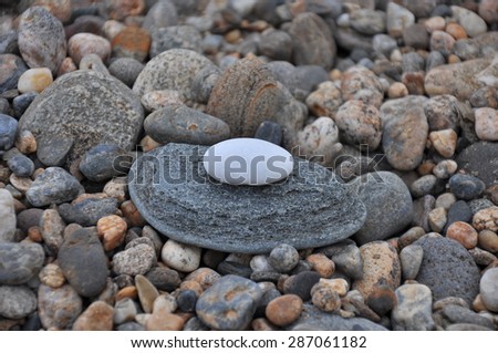 Round textured stones in sunlight near the river