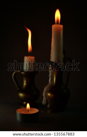 Three candles in the darkness