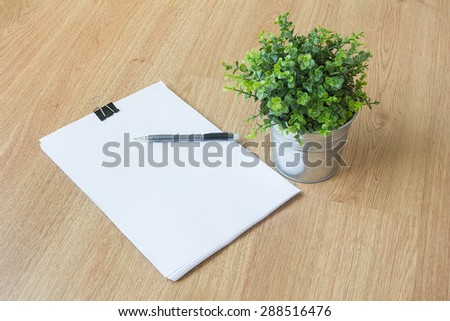 paper and pen on wooden floor