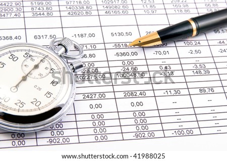 Closeup of an income statement with a pen and stopwatch.