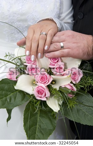 stock photo Bride and groom holding hands with wedding rings on bridal 