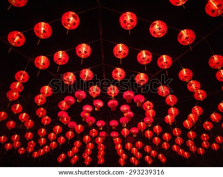 The multi circle form layer of light-up red Chinese style  paper lantern at night with dark black sky as background. There are two similar images, one wide angle shot and the other close up shot.