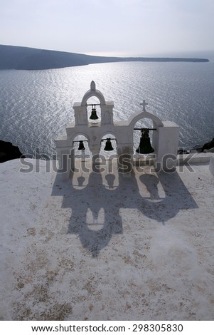 see bells in oia of santorini. One of the famous tourist attractive scenic view of sea bells in good afternoon sunny day with nice casted shadow and beautiful sea view of calm cloudless beauty sky.