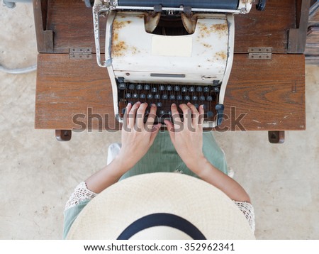 Unidentified woman's hand typing on retro typing machine