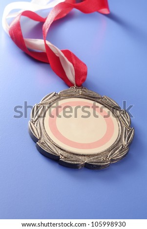 close up of the medal on the green board