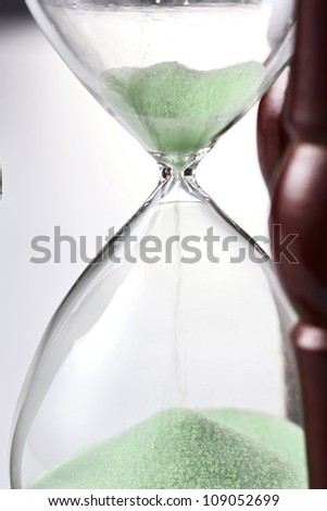 Sand funneling through hour glass