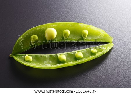 Close up of pea pod and peas